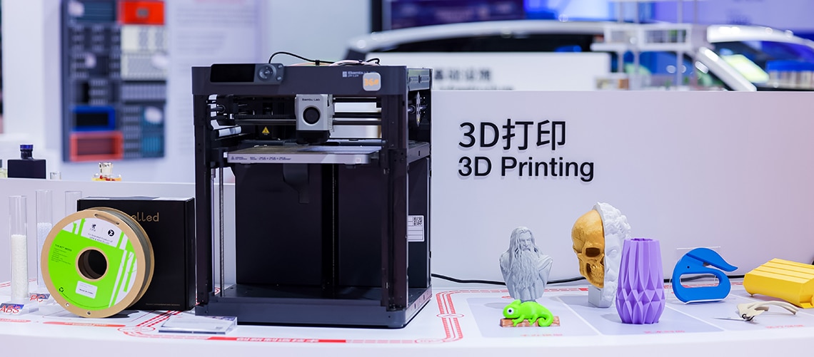 3D printer next to some 3D printed objects 3D printer next to some 3D printed objects