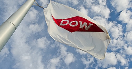 The Dow Diamond on a white flag flying against a partly cloudy sky