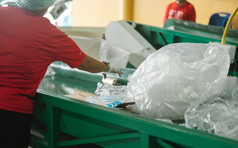 a recycler sorts material for recycling