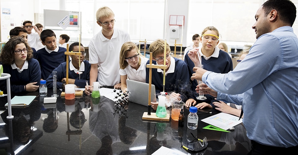 Diverse group of students participate in a STEM event lab experiment.