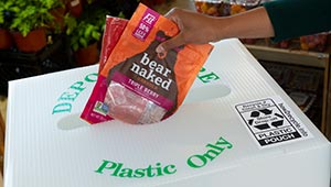Bare Naked granola packaging being placed into recycle container