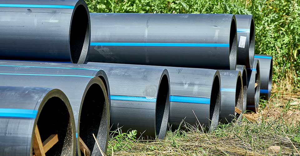 stacks of HDPE pipes await installation