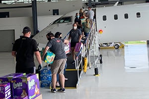 Volunteers unload planes carrying donations from Louisiana and Texas