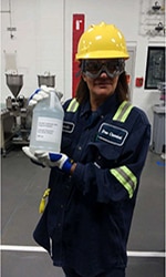 Dow frontline employee holding raw material for hand sanitizer production