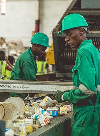 Workers sort recyclable material