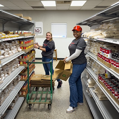 Dow volunteers fills shelves with food