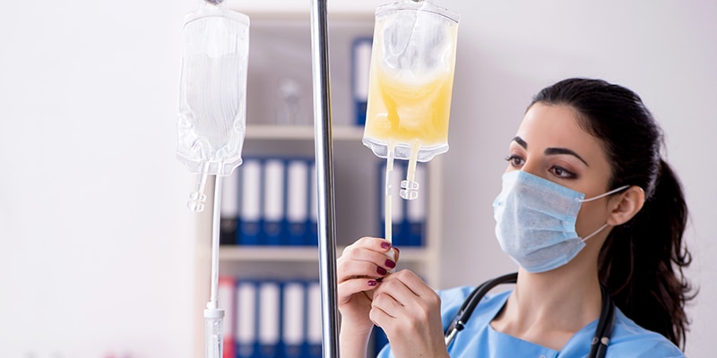 Nurse hanging I.V. bags