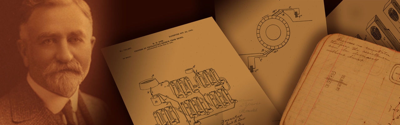 herbert henry dow with pages of blueprints graphic