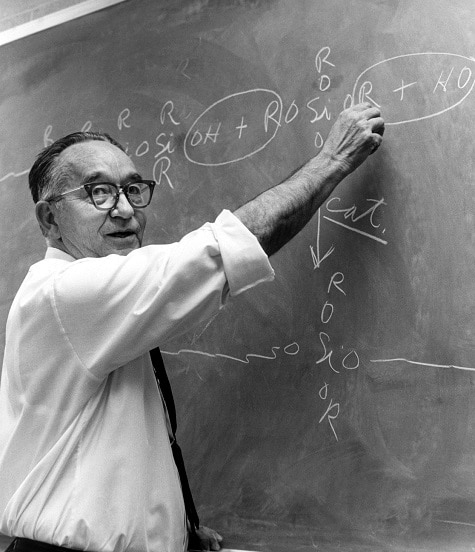Dr. Hyde at blackboard explaining some formulas to workers at the Midland Plant. He has his sleeves rolled up and he is pointing to a specific part of the formula as he turns to face who he's talking too. Photo used in 50th Anniversary Book page 22.