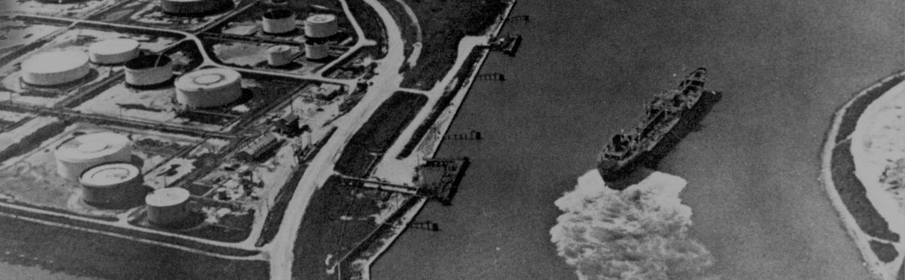 black and white photo of dock and ship