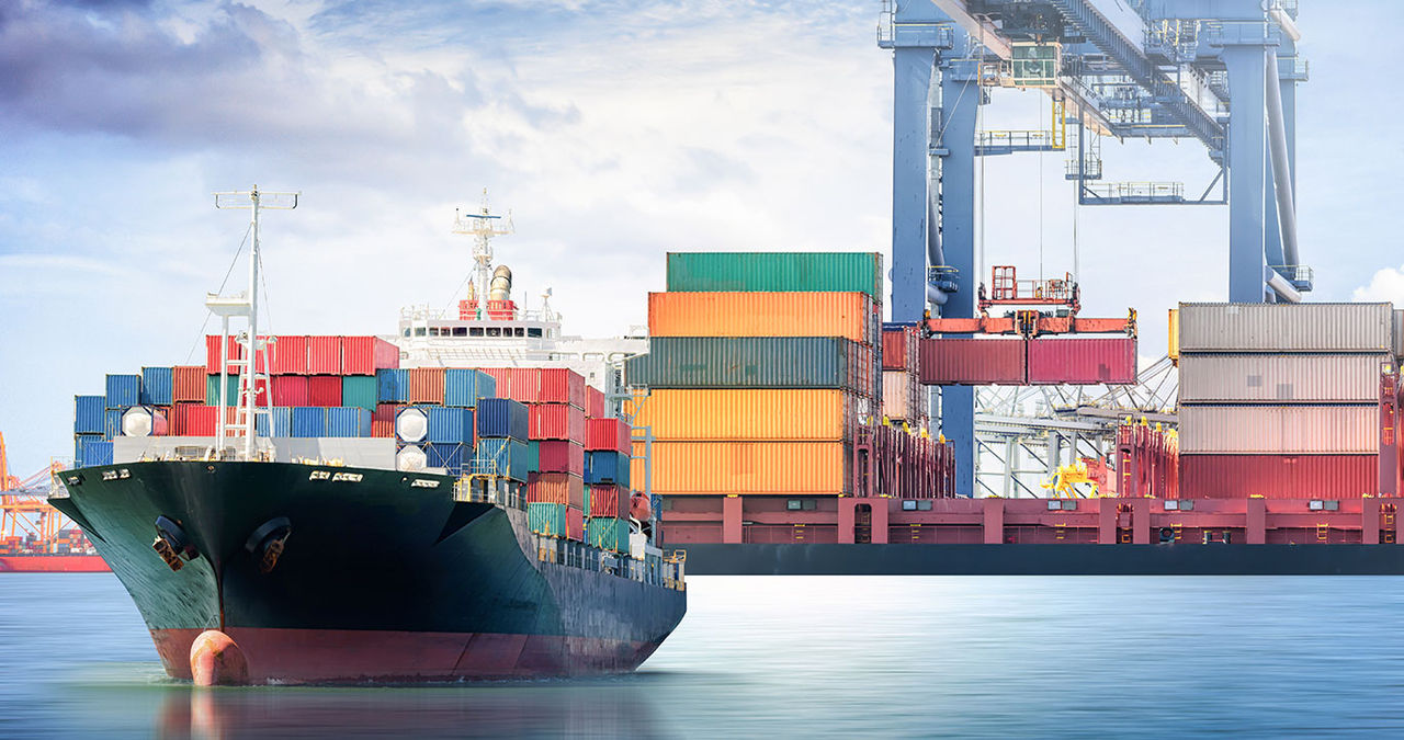Cargo ship sailing away from loading dock