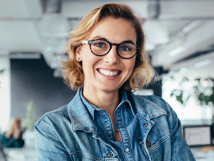 woman with glasses smiling