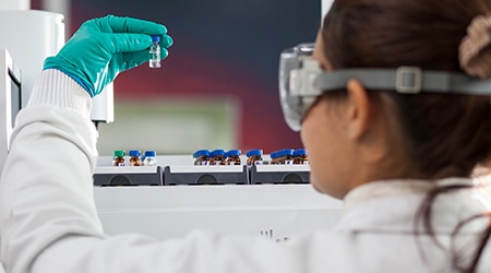 scientist examining a vial
