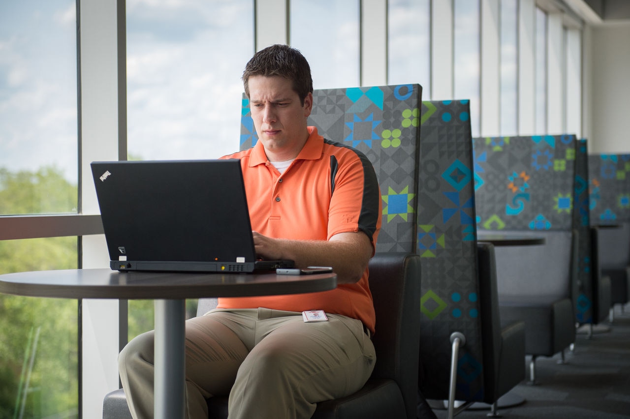 a man sitting at a laptop