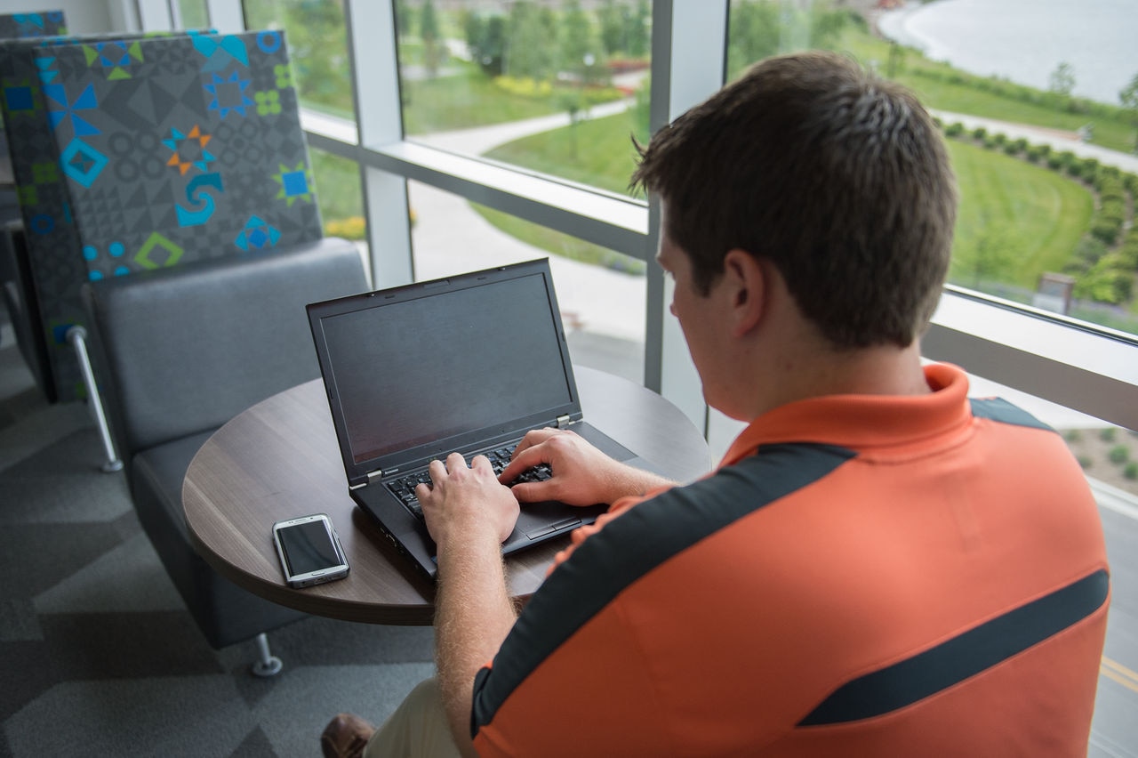 Man with headphones working at a desk