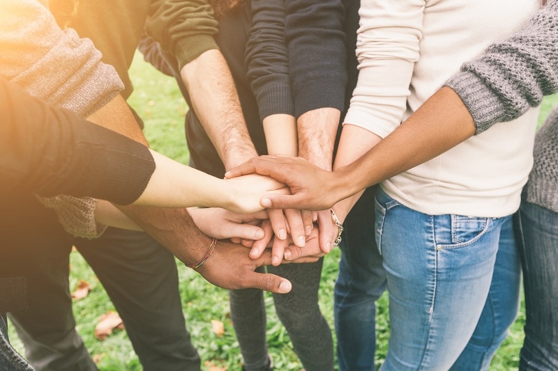 friends with hands in stack