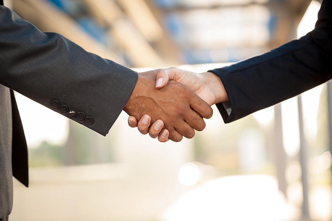 Business man and woman shaking hands.
