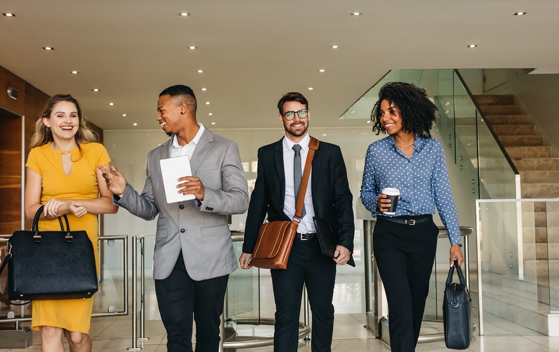 business professionals walking together in office hallway