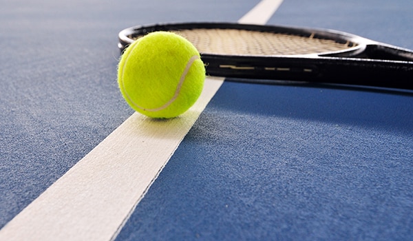 tennis racket and ball on a court