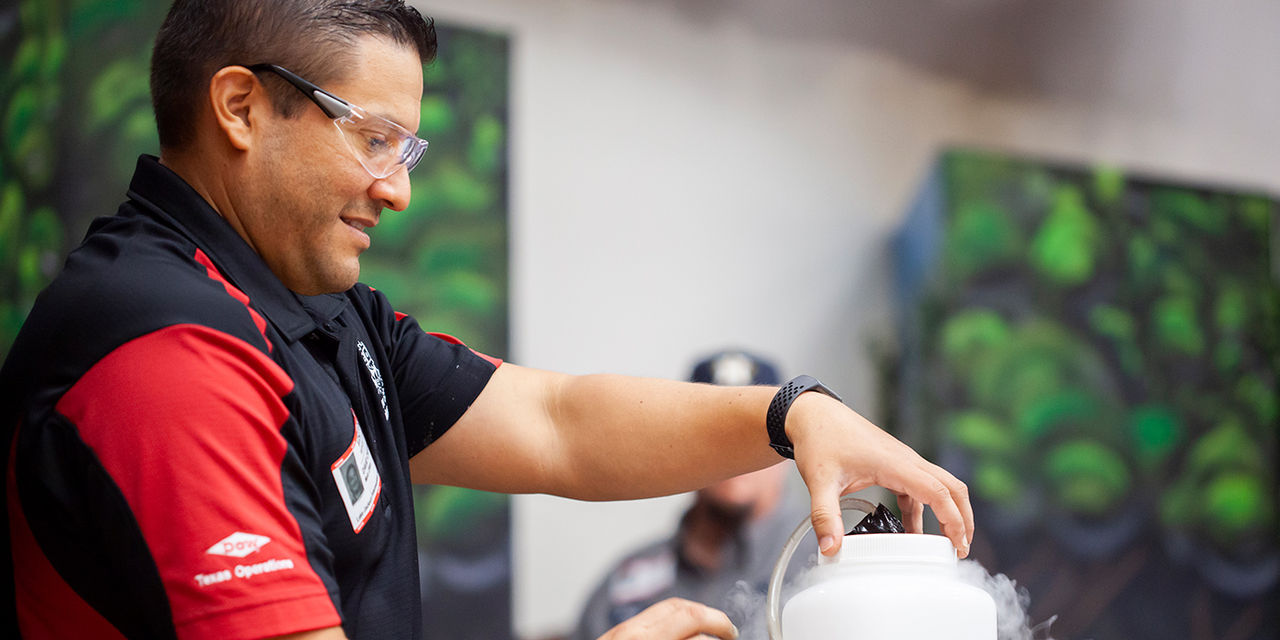 Dow representative demonstrates a STEM experiment