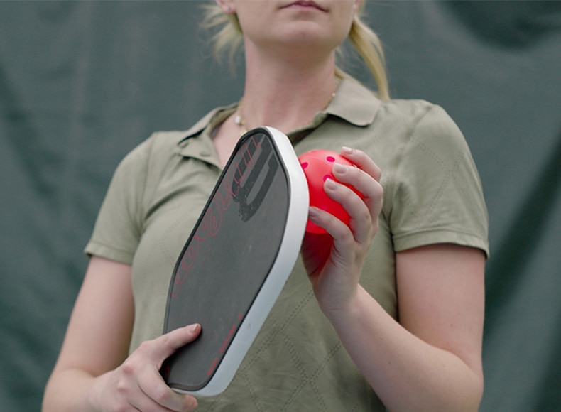 woman with a wilson pickleball and racket