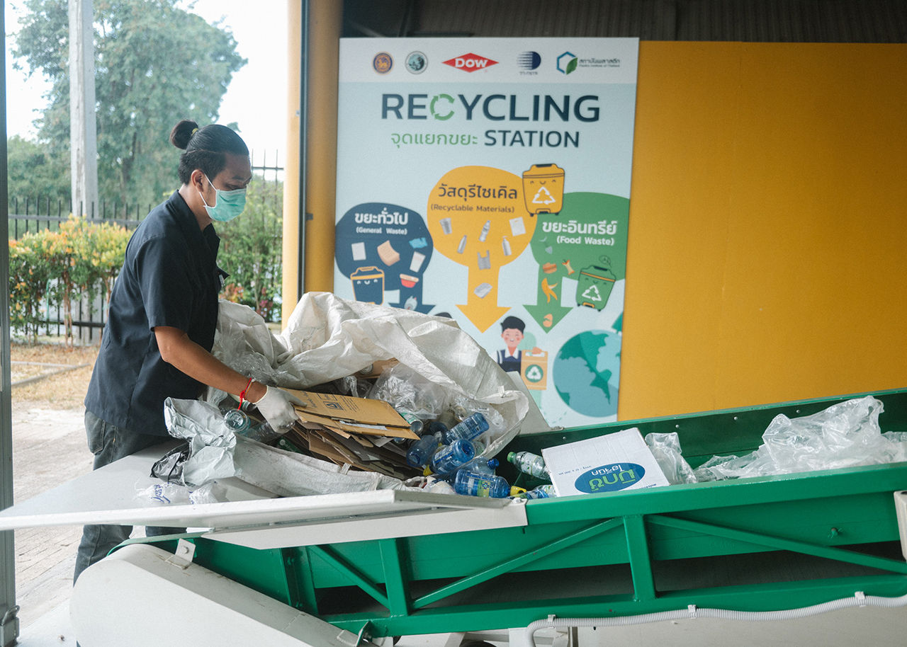 A recycler loads material into the recycling equipment