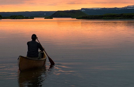 man in canoe looking at horizon