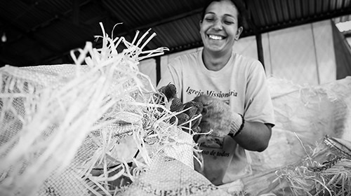 A waste collector in Brazil sorts recyclable materials