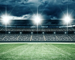 Athletic field with bleachers in the background