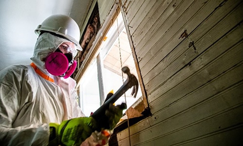 Team Rubicon Greyshirt volunteer mucks out a home during the Kentucky Flooding Operations in September 2022.