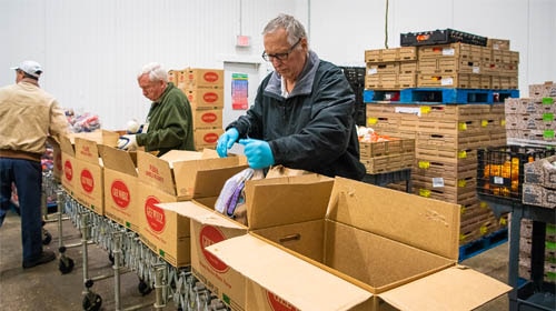 volunteers at Produce Resource Center pack food