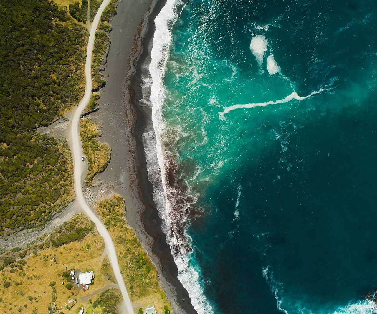 aerial view of waves crashing the shore
