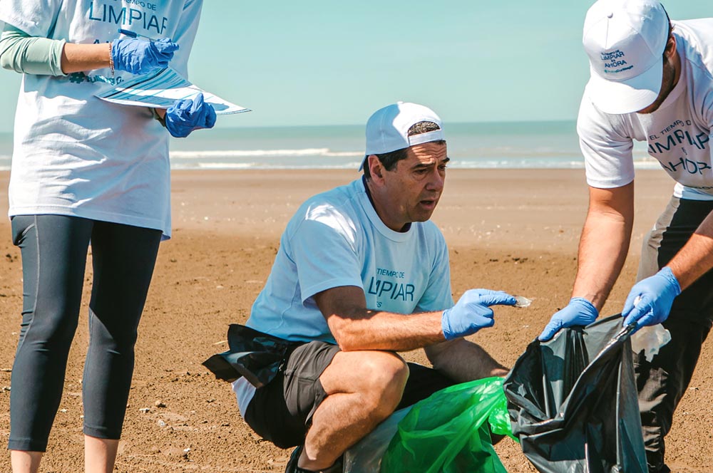 volunteers help clean a beach