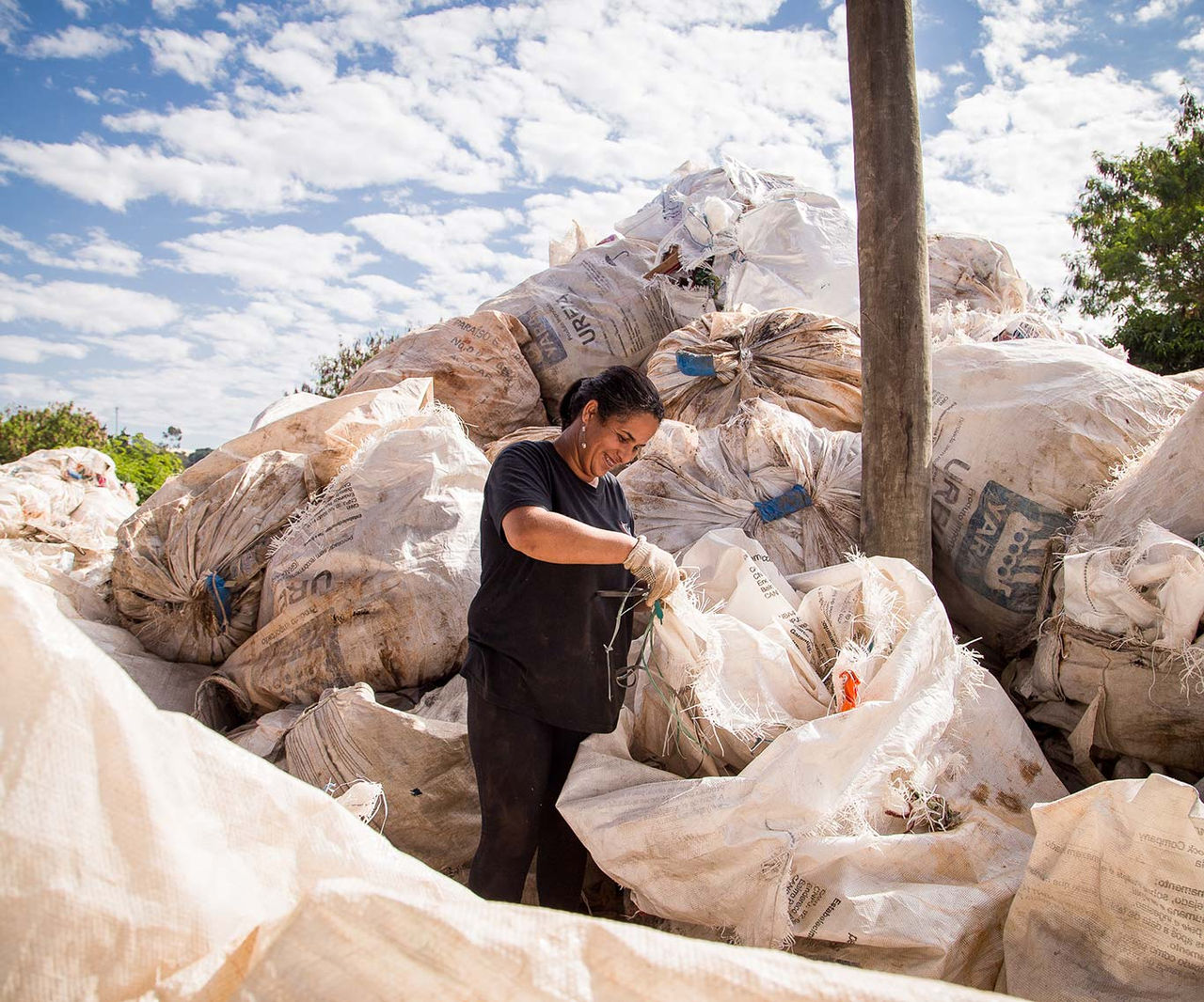 woman packaging plastic waste for recycling