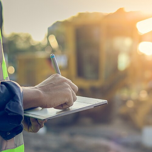 construction worker takes notes