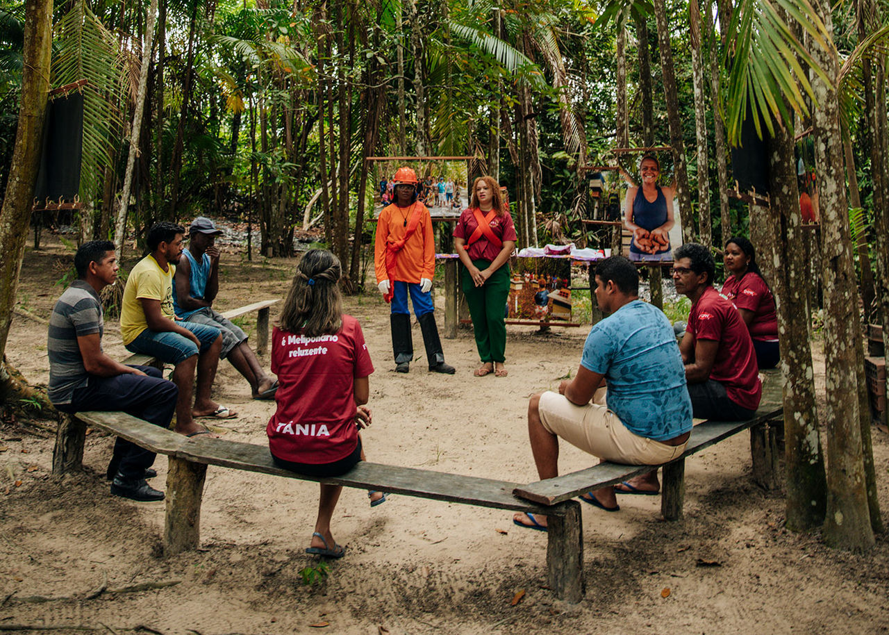 Locals and volunteers discuss Project Yba in the Amazon