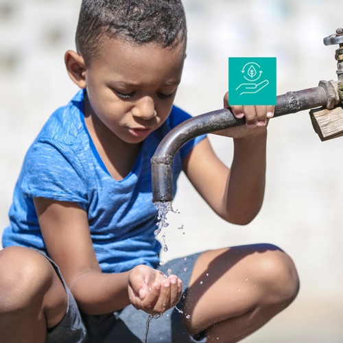 boy getting water from faucet