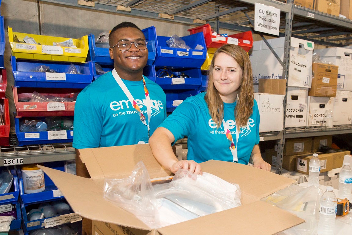 Two Dow volunteers packing boxes at an event