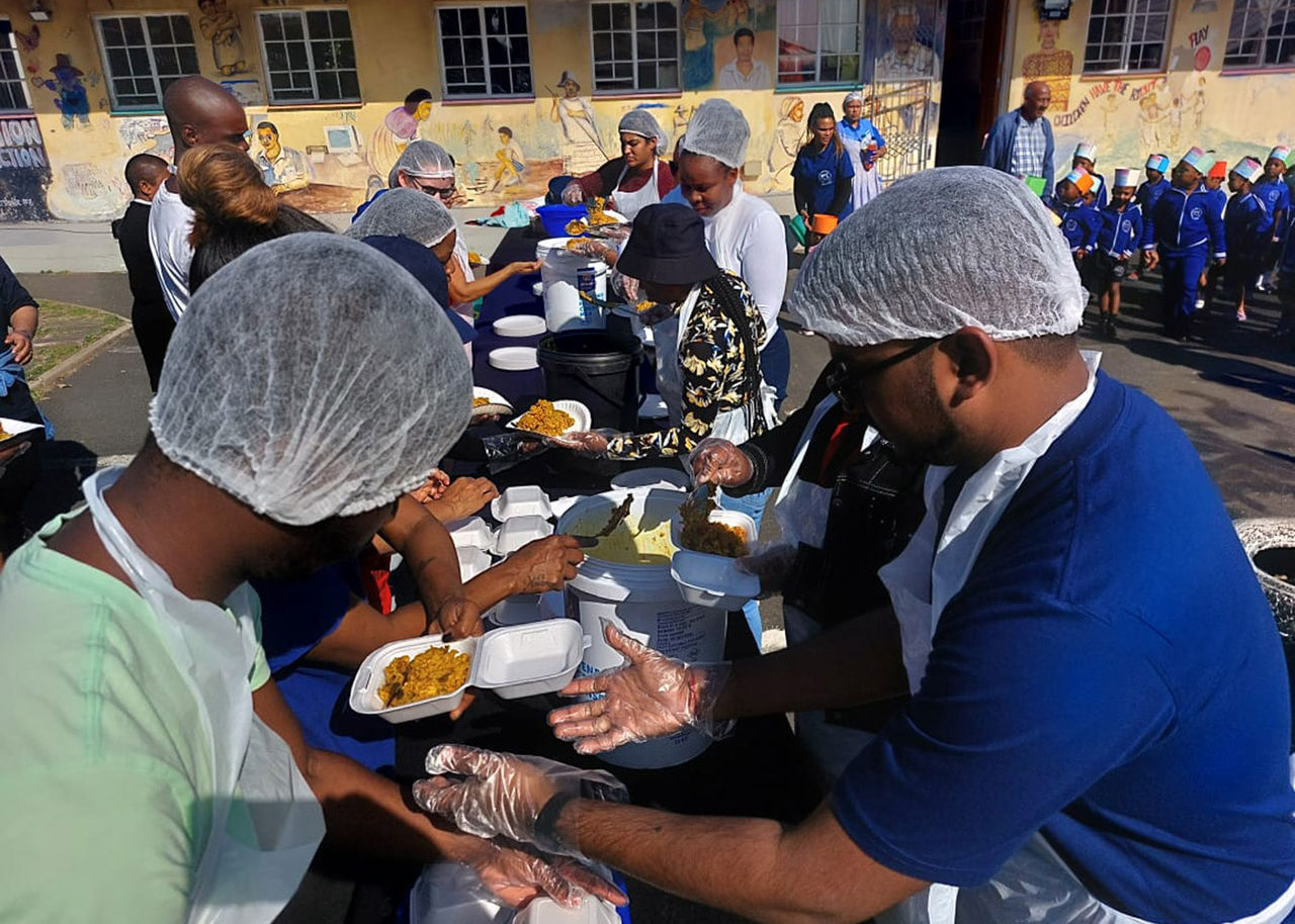 volunteers distribute food at a community event