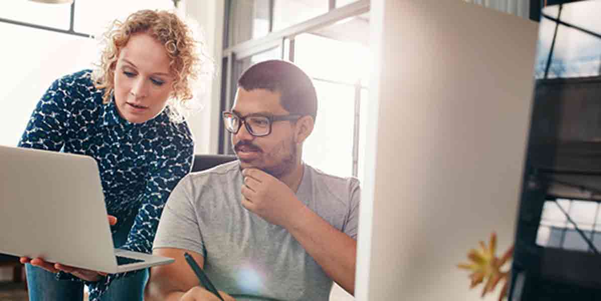 Woman and man looking at a computer together