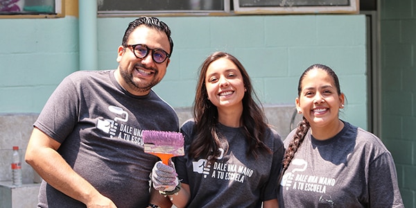 volunteers help paint a school in Mexico