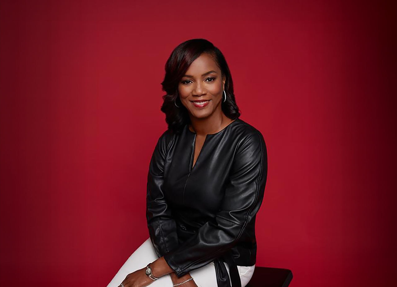 Alveda Williams wearing a purple jacket