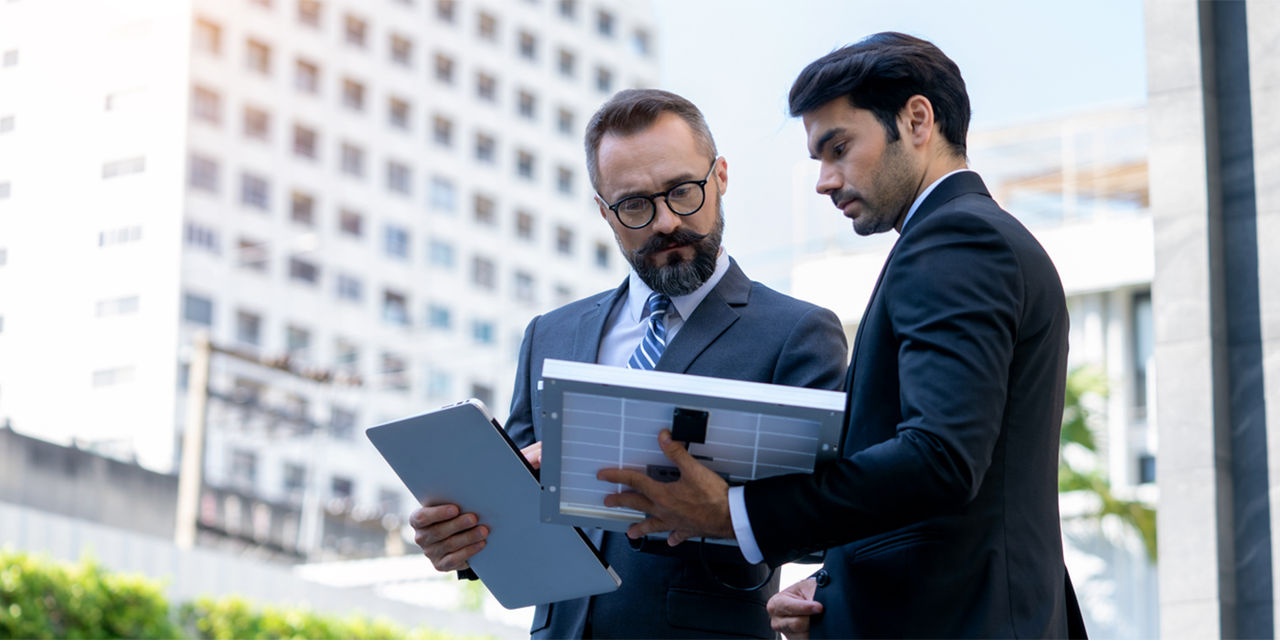 two colleagues look at tablets
