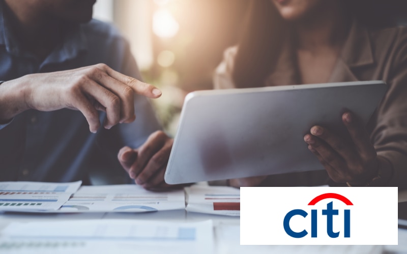two people looking at a tablet with the Citi logo