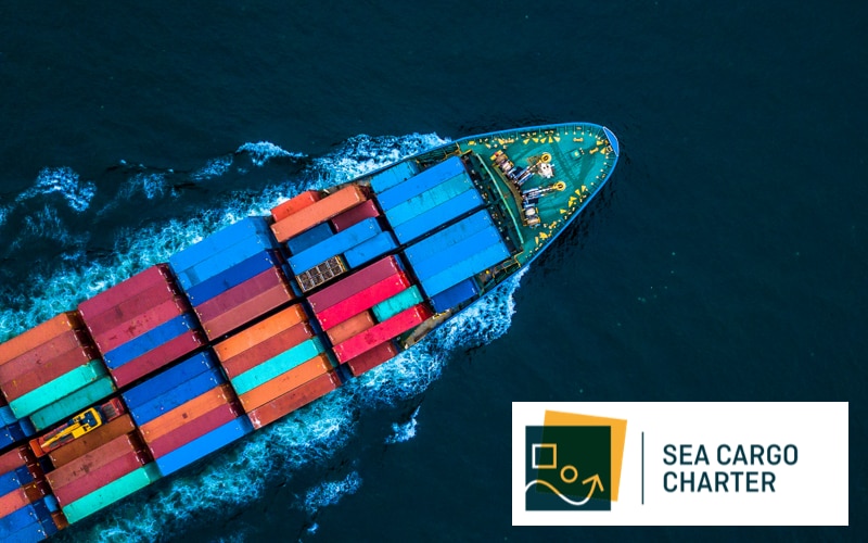 cargo ship at sea with the Sea Cargo Charter logo