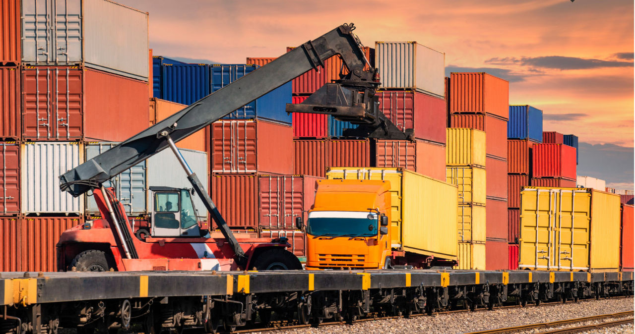 shipping containers being loaded to truck