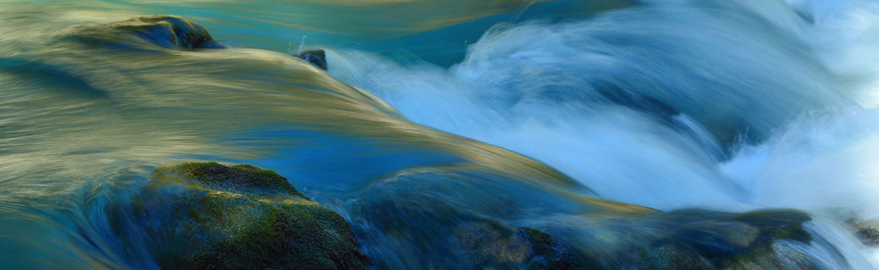 river flowing over mossy rocks