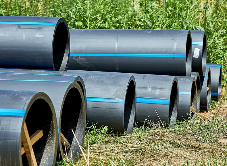 stacks of HDPE pipes await installation