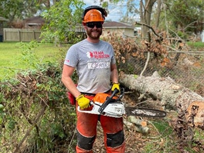 Chase Roberts, Dow Team Rubicon lead, removes debris during Hurricane Laura Relief efforts in Orange, Texas, in October 2020.
