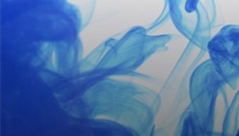 Blue dye swirls in tank of water
